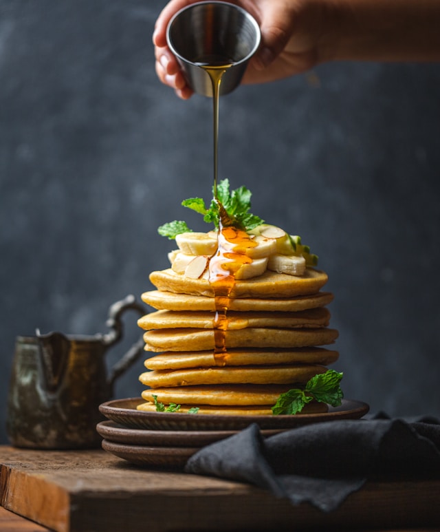 Sweet Delight: Drizzling honey over perfect pancakes